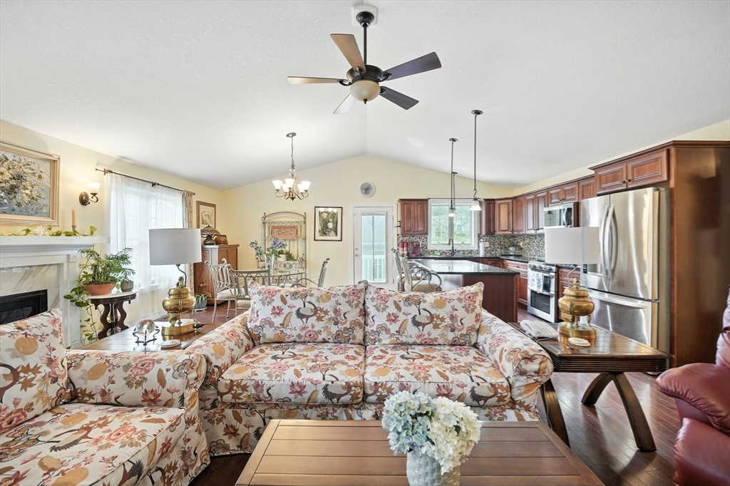 46 Palmer Road, Unit 28 Monson, MA 01057 - Photo 11 of 38 a living room with furniture a fireplace and a chandelier