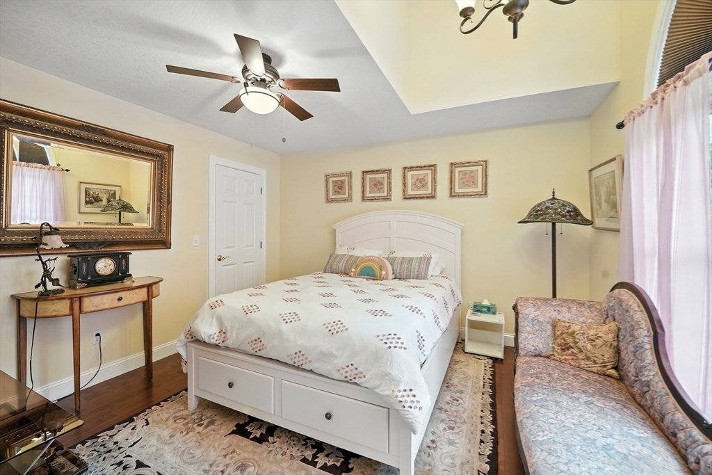 46 Palmer Road, Unit 28 Monson, MA 01057 - Photo 15 of 38 a bedroom with a bed and wooden floor