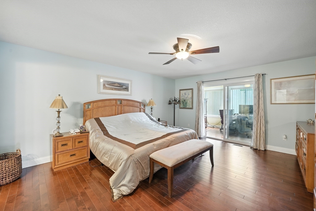 46 Palmer Road, Unit 28 Monson, MA 01057 - Photo 18 of 38 a bedroom with a bed and wooden floor