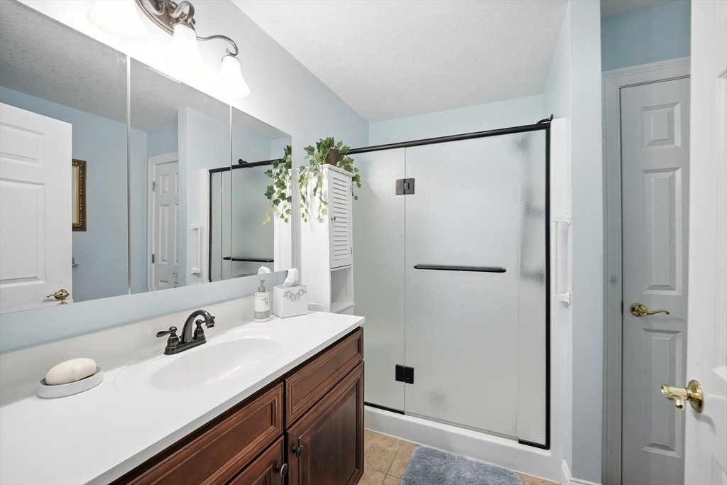 46 Palmer Road, Unit 28 Monson, MA 01057 - Photo 24 of 38 a bathroom with a double vanity sink mirror and shower