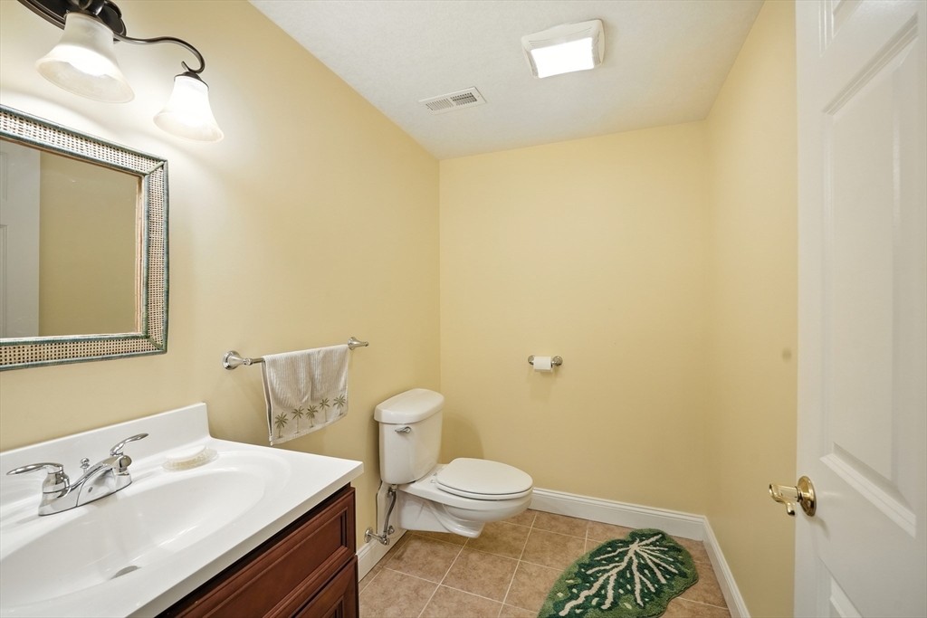 46 Palmer Road, Unit 28 Monson, MA 01057 - Photo 30 of 38 a bathroom with a sink a toilet and a mirror