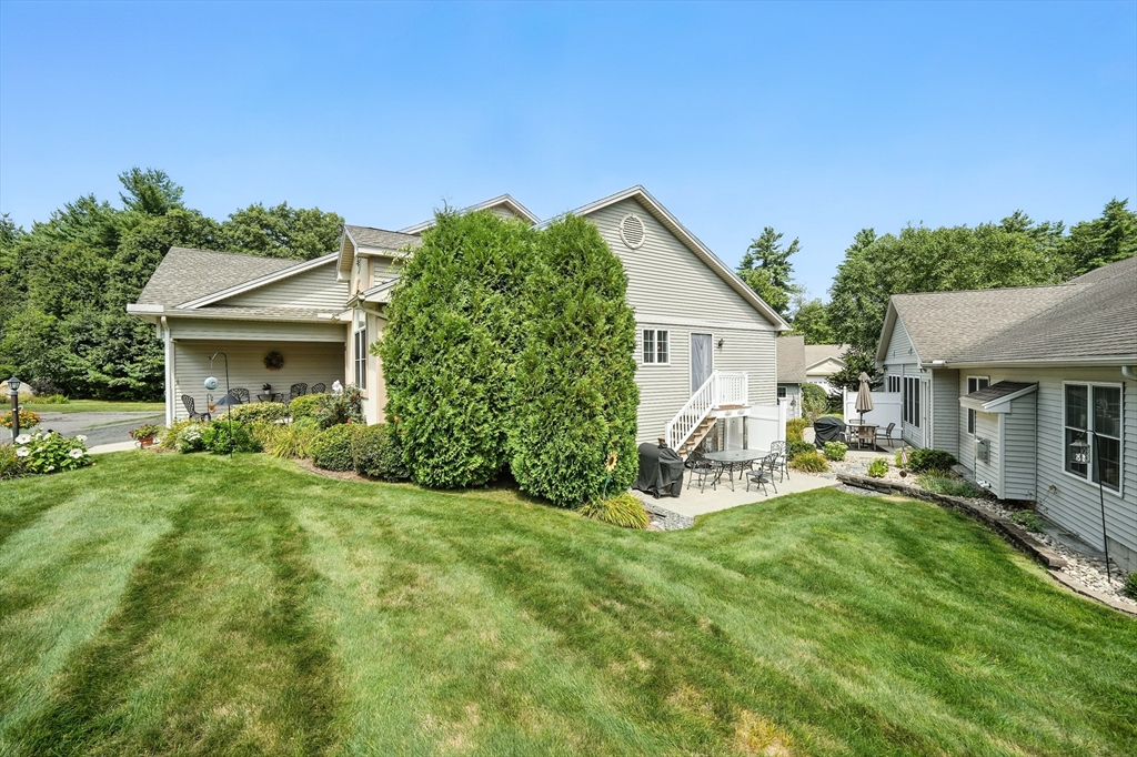 46 Palmer Road, Unit 28 Monson, MA 01057 - Photo 36 of 38 a view of a house with a yard and sitting area