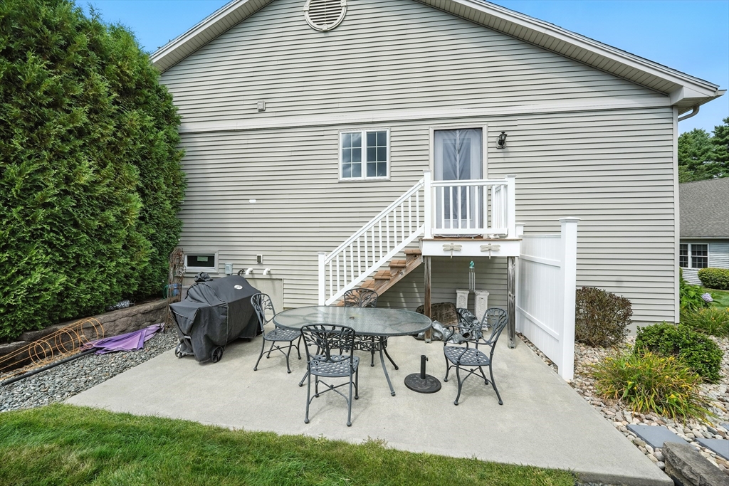 46 Palmer Road, Unit 28 Monson, MA 01057 - Photo 38 of 38 a view of backyard with table and chairs and potted plants