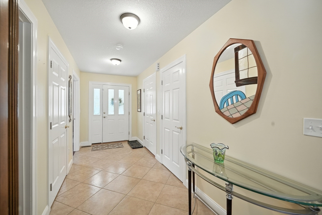 46 Palmer Road, Unit 28 Monson, MA 01057 - Photo 4 of 38 a view of an entryway with wooden floor and mirror