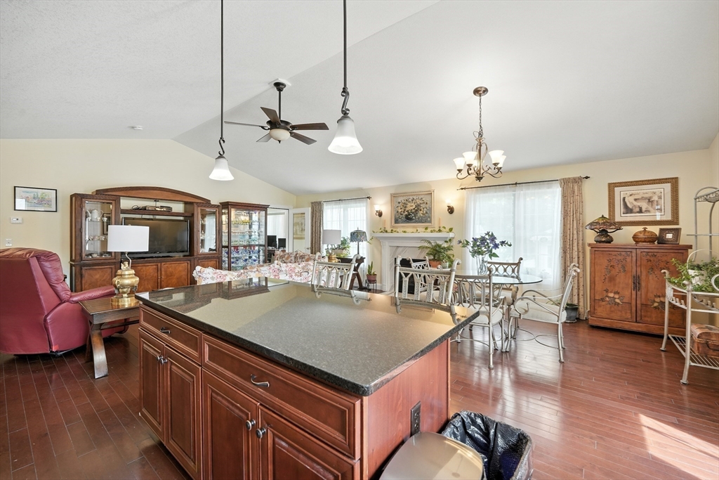 46 Palmer Road, Unit 28 Monson, MA 01057 - Photo 6 of 38 a view of a dining room and livingroom with furniture wooden floor a chandelier