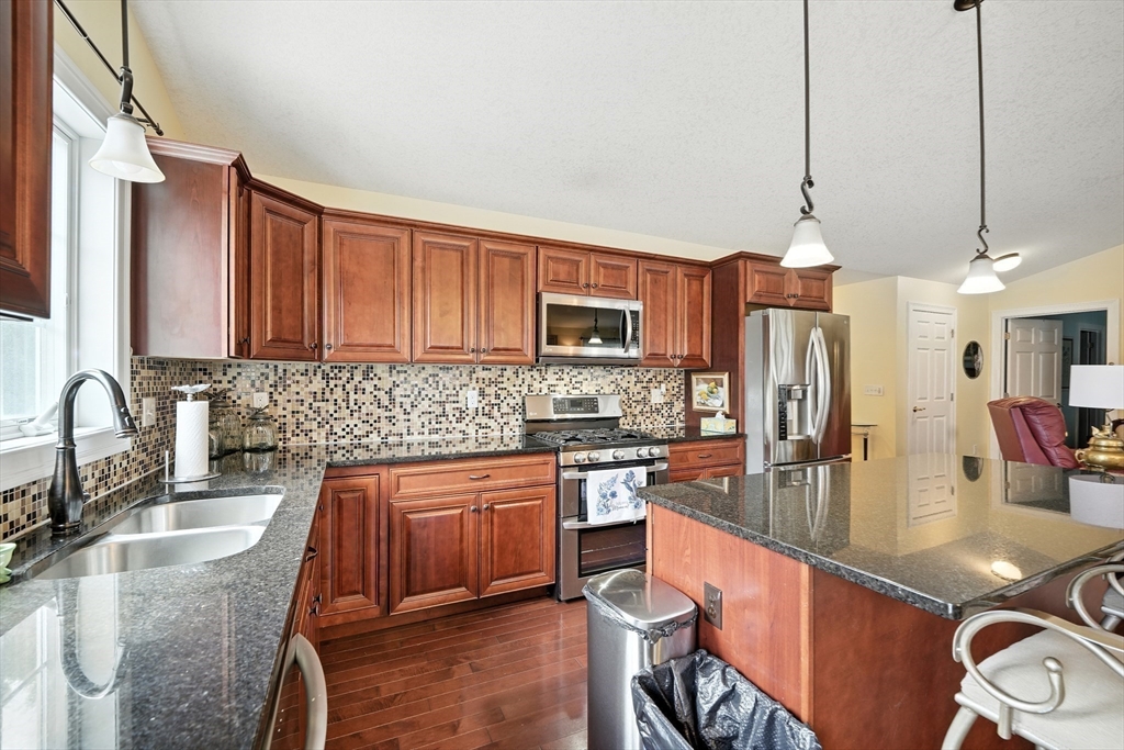 46 Palmer Road, Unit 28 Monson, MA 01057 - Photo 7 of 38 a kitchen with stainless steel appliances granite countertop a sink stove and refrigerator