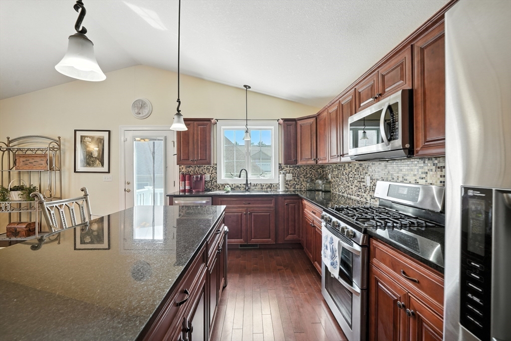 46 Palmer Road, Unit 28 Monson, MA 01057 - Photo 8 of 38 a kitchen with stainless steel appliances granite countertop a stove and cabinets