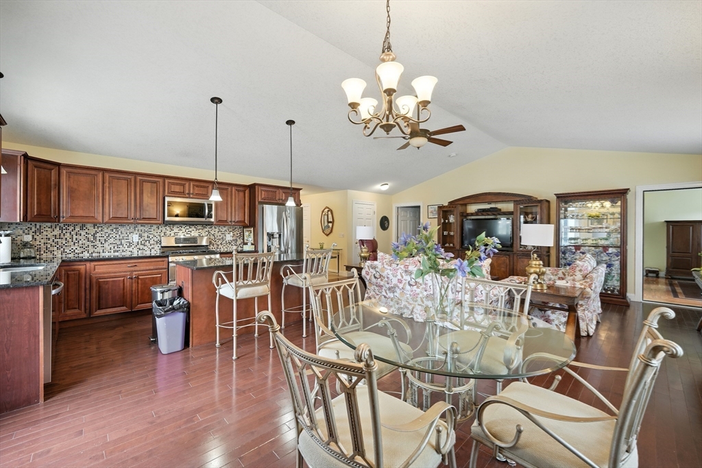 46 Palmer Road, Unit 28 Monson, MA 01057 - Photo 9 of 38 a view of a dining room and livingroom with furniture wooden floor a chandelier