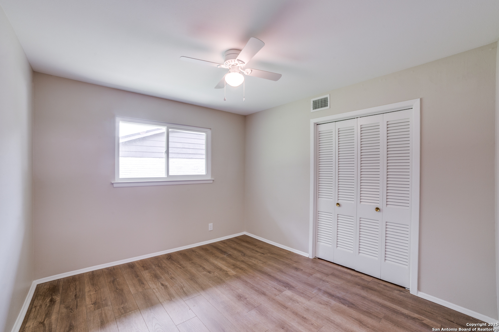 3323 Old Forge San Antonio, TX 78230 - Photo 20 of 26 a view of an empty room with wooden floor and a window