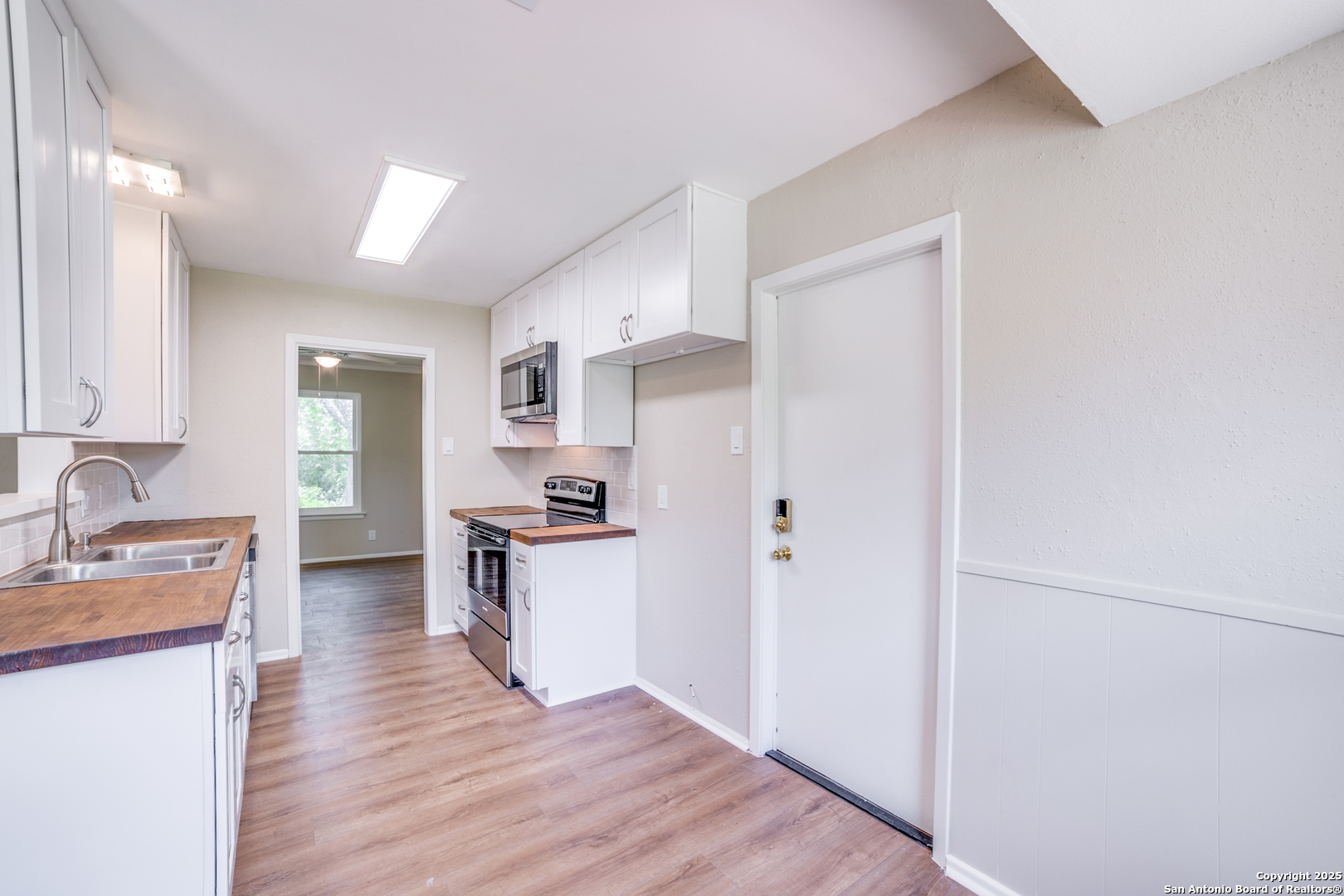 3323 Old Forge San Antonio, TX 78230 - Photo 10 of 26 a kitchen with a refrigerator and a sink