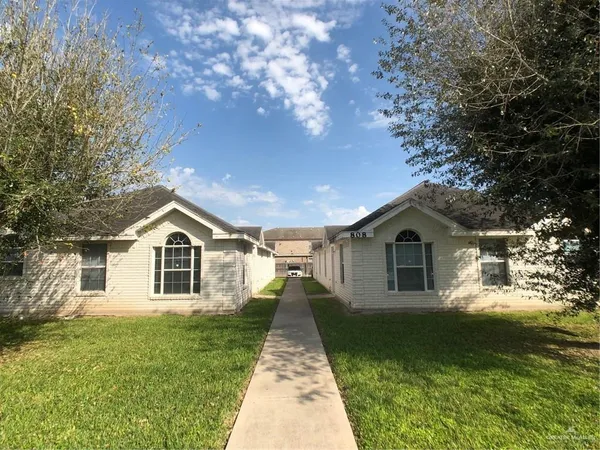 a front view of a house with yard