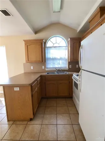 a kitchen with stainless steel appliances granite countertop a sink and a stove