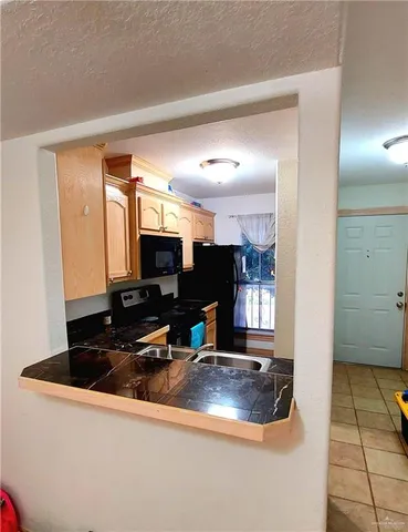 a kitchen with a sink and a refrigerator