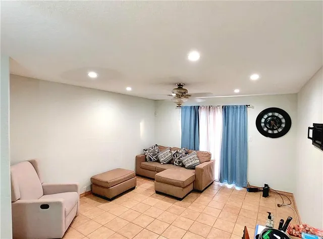 a living room with furniture a rug and wall clock