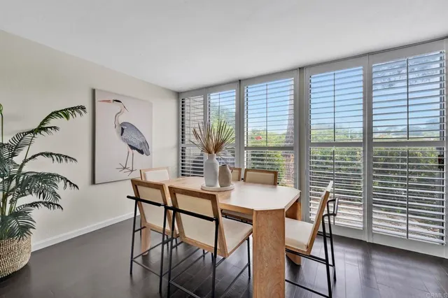 a dining room with furniture and wooden floor