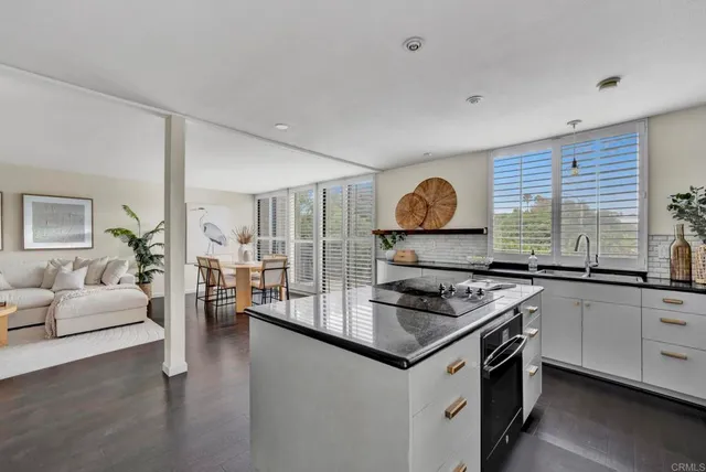 a kitchen with stainless steel appliances granite countertop a stove and a sink