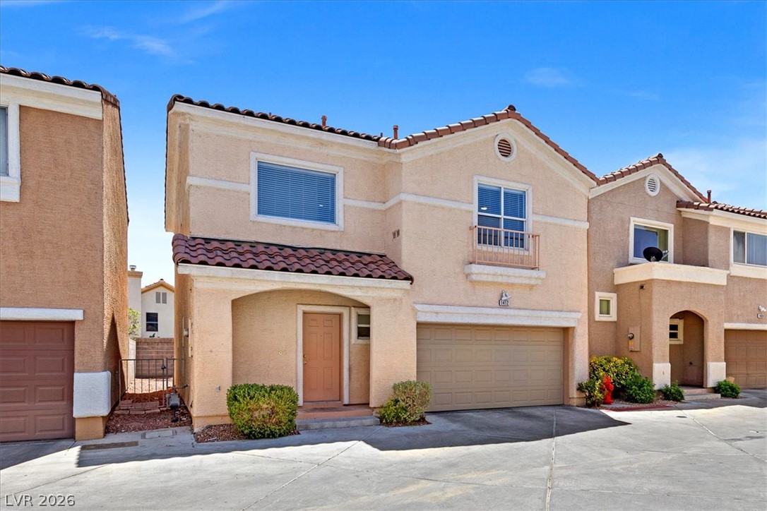1412 Beaver Spring Street Las Vegas, NV 89128 - Photo 2 of 20 A terracotta-tiled roof crowns this residence, featuring a single-car garage and welcoming front entry.