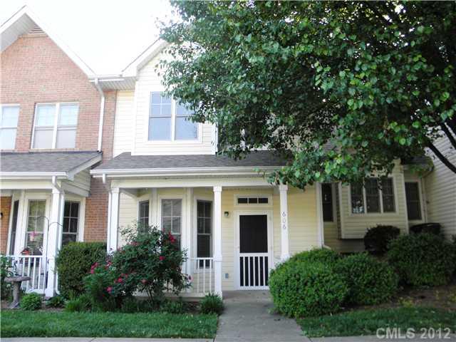 606 Stone Village Drive, Unit 606 Fort Mill, SC 29708 - Photo 1 of 11 a front view of a house with a yard garage and outdoor seating