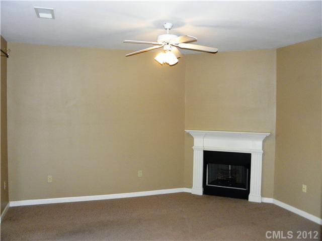 606 Stone Village Drive, Unit 606 Fort Mill, SC 29708 - Photo 2 of 11 a view of an empty room with a fireplace