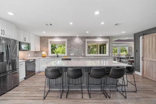 a kitchen with lots of counter top space and refrigerator