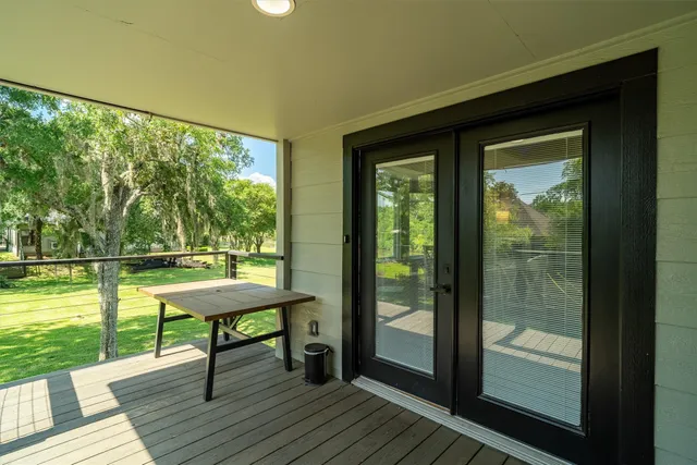 a view of a balcony with wooden floor and outdoor space