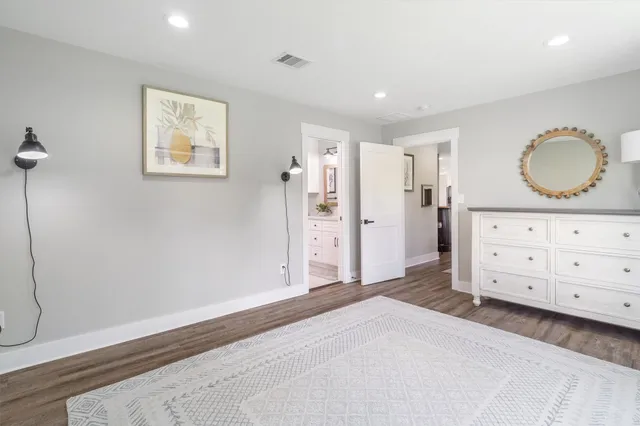 a bedroom with a bed and a dresser