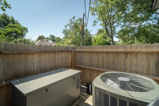 a view of a house with a big yard plants and large trees