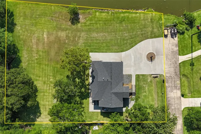 an aerial view of a houses with a lake view