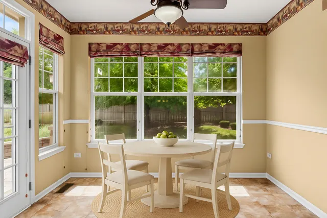 a view of an empty room with a window and chandelier