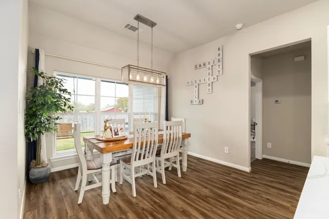 a view of a dining room with furniture window and wooden floor