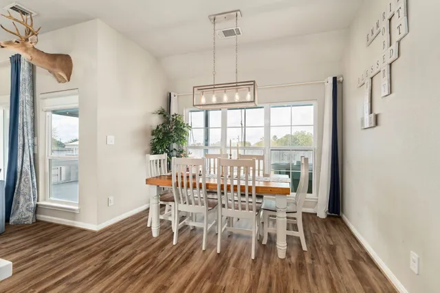 a view of a dining room with furniture window and wooden floor