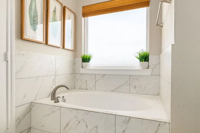 a bathroom with a bathtub and window