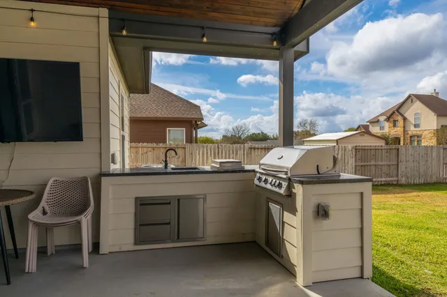 a kitchen with a sink a stove and a microwave