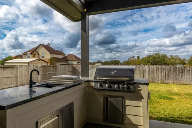 a view of a porch with chairs and floor to ceiling window
