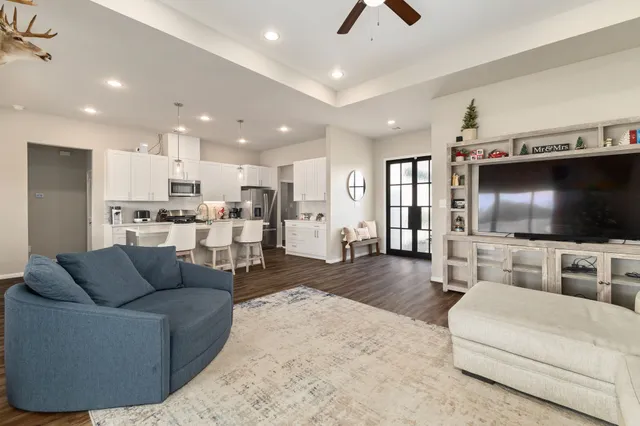 a living room with furniture and a flat screen tv