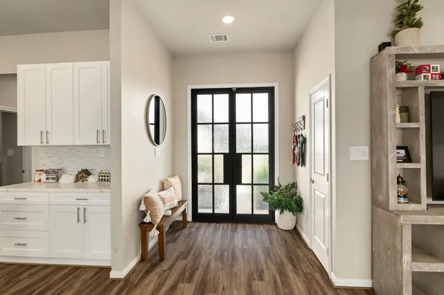 a view of a kitchen with furniture and entryway
