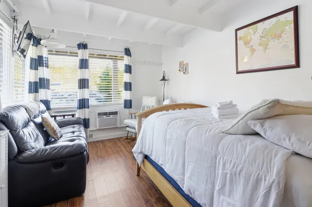 a bedroom with a bed and a large window