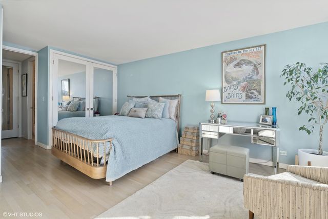 a living room with furniture a couch and paintings on the wall