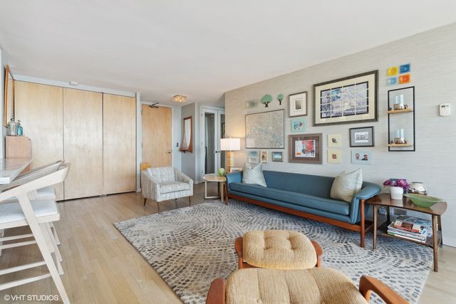 a living room with furniture a rug and a table