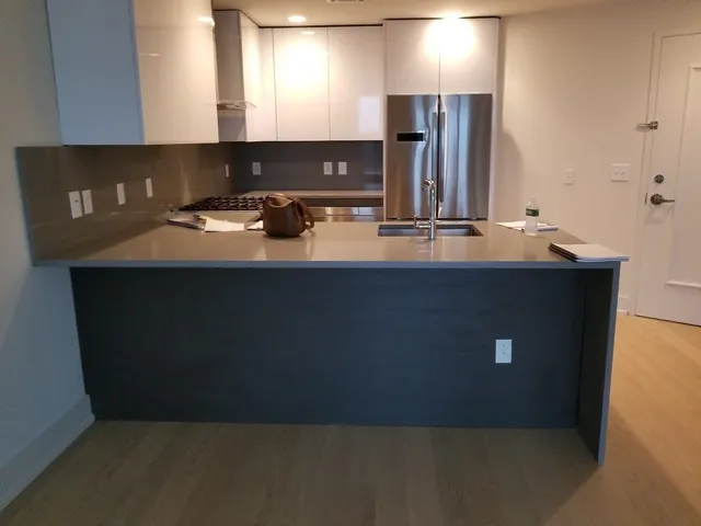 a kitchen with kitchen island sink