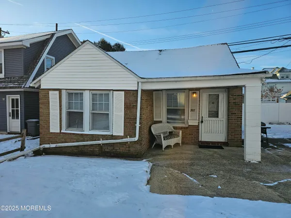 a front view of a house with sitting area