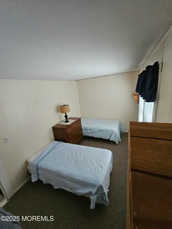 a bedroom with a bed and flat screen tv
