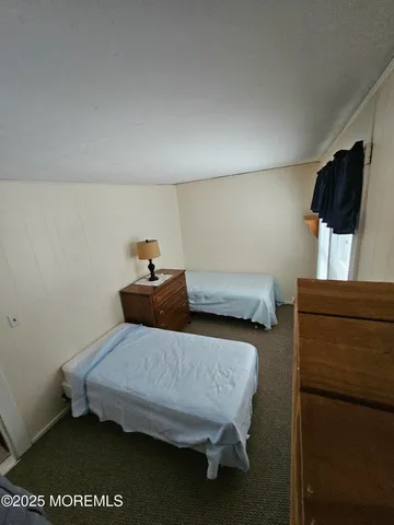 a bedroom with a bed and flat screen tv