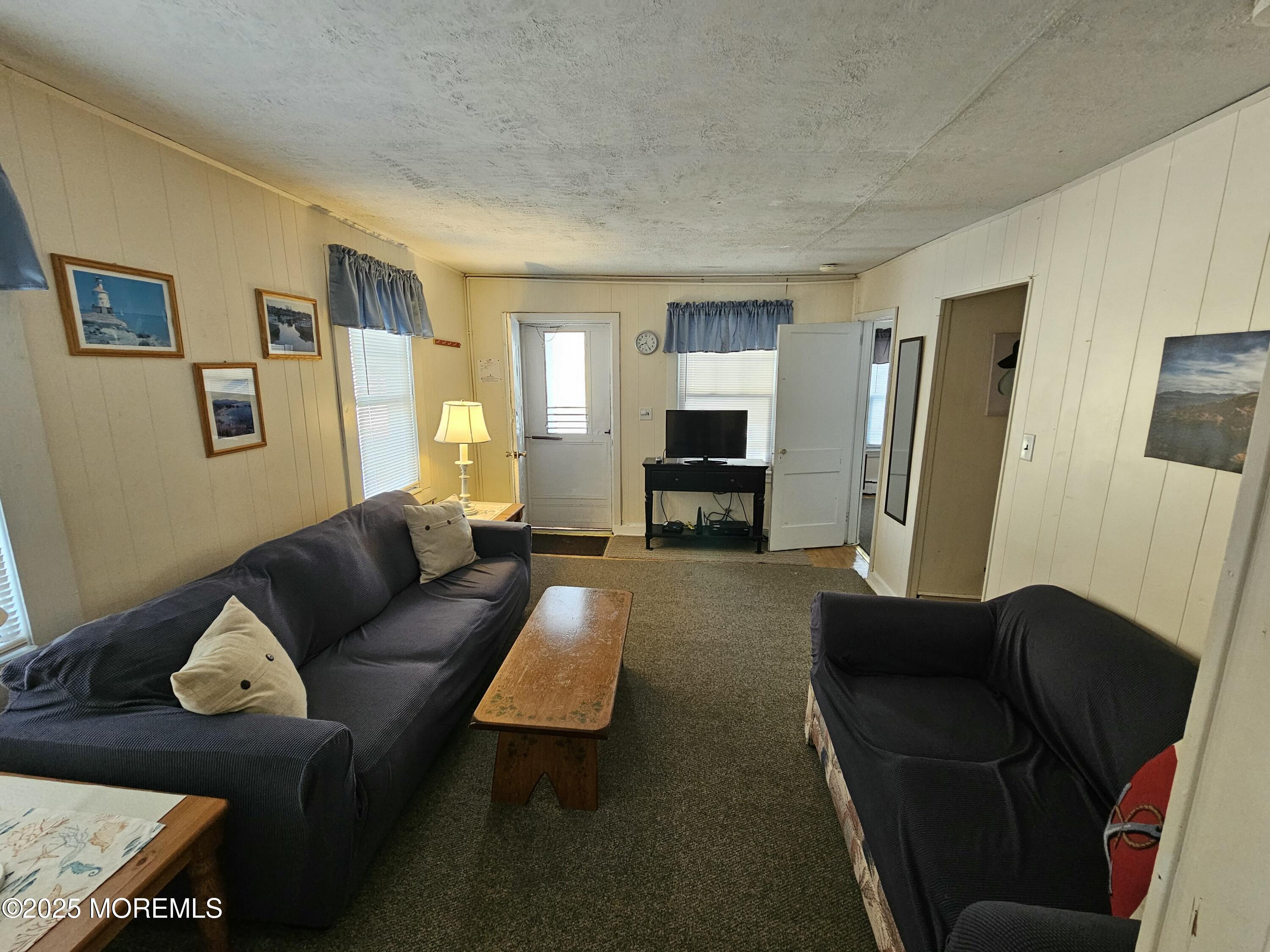 207 3rd Avenue, Unit REAR Belmar, NJ 07719 - Photo 3 of 13 a living room with furniture and a flat screen tv