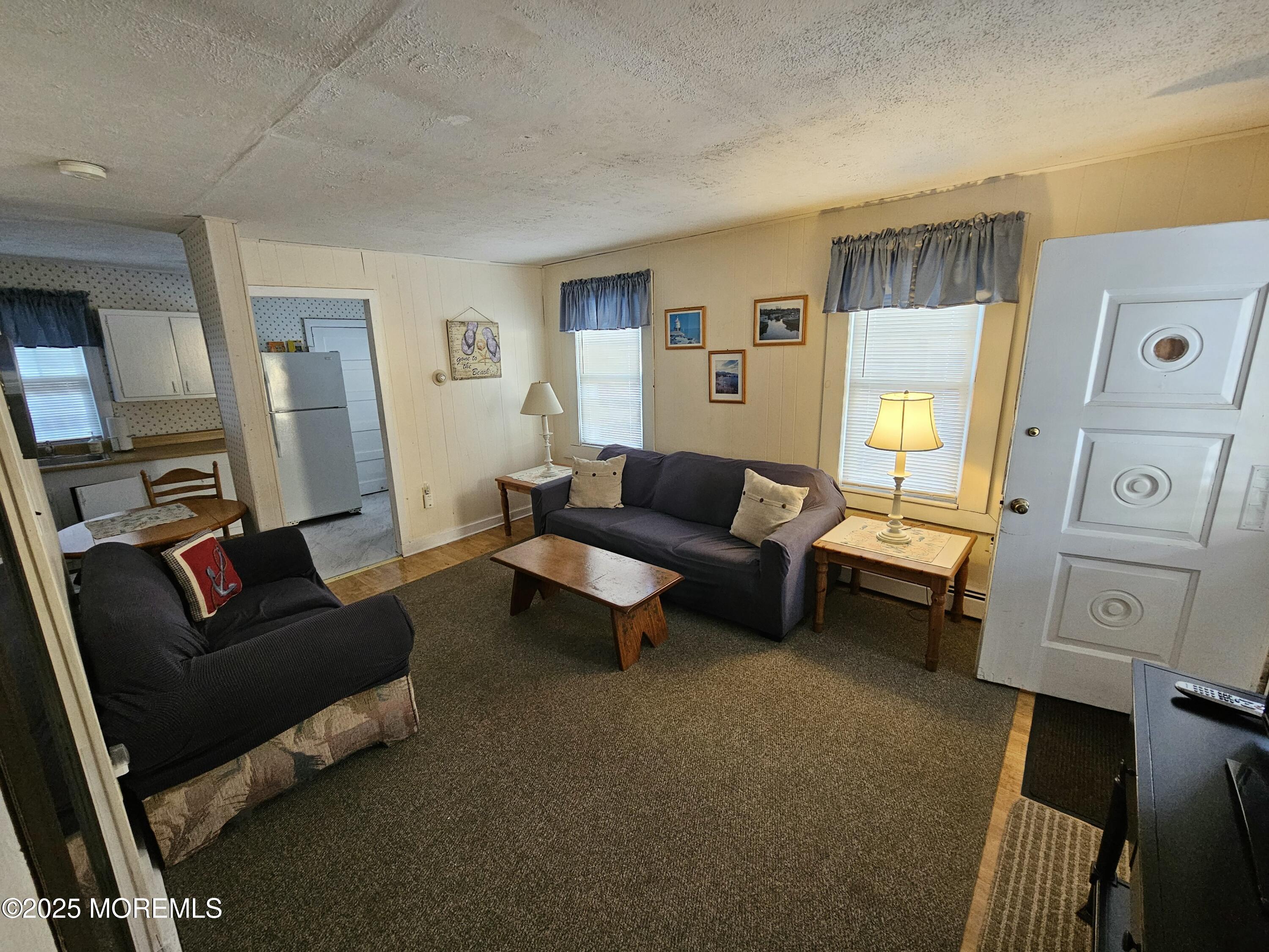 207 3rd Avenue, Unit REAR Belmar, NJ 07719 - Photo 5 of 13 a living room with furniture and a flat screen tv