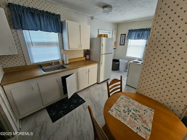 a kitchen with sink cabinets and window