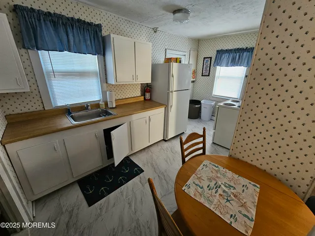 a kitchen with sink cabinets and window