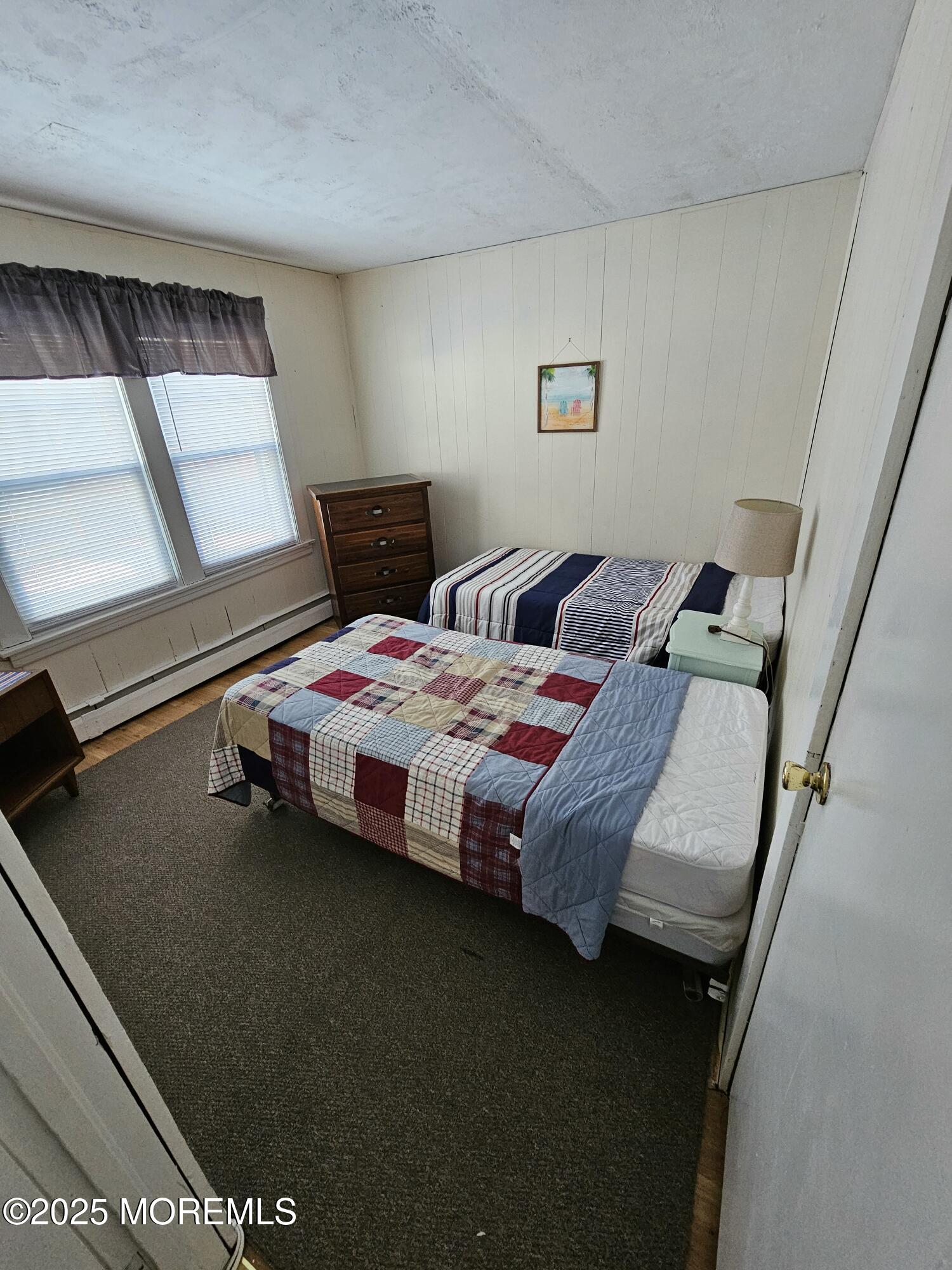 207 3rd Avenue, Unit REAR Belmar, NJ 07719 - Photo 8 of 13 a bedroom with a bed and a window