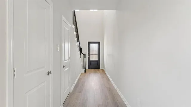 a view of a hallway with wooden floor