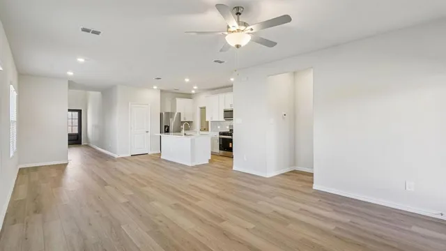 a view of a kitchen with a sink and a refrigerator